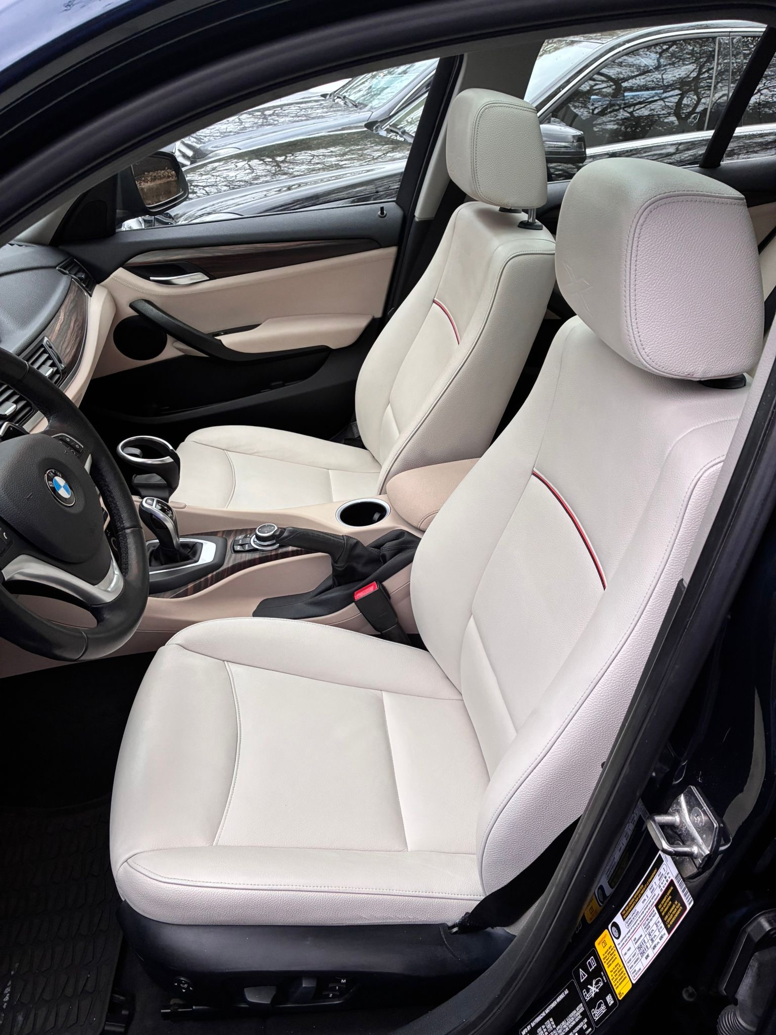 Interior view of a BMW car featuring beige leather seats